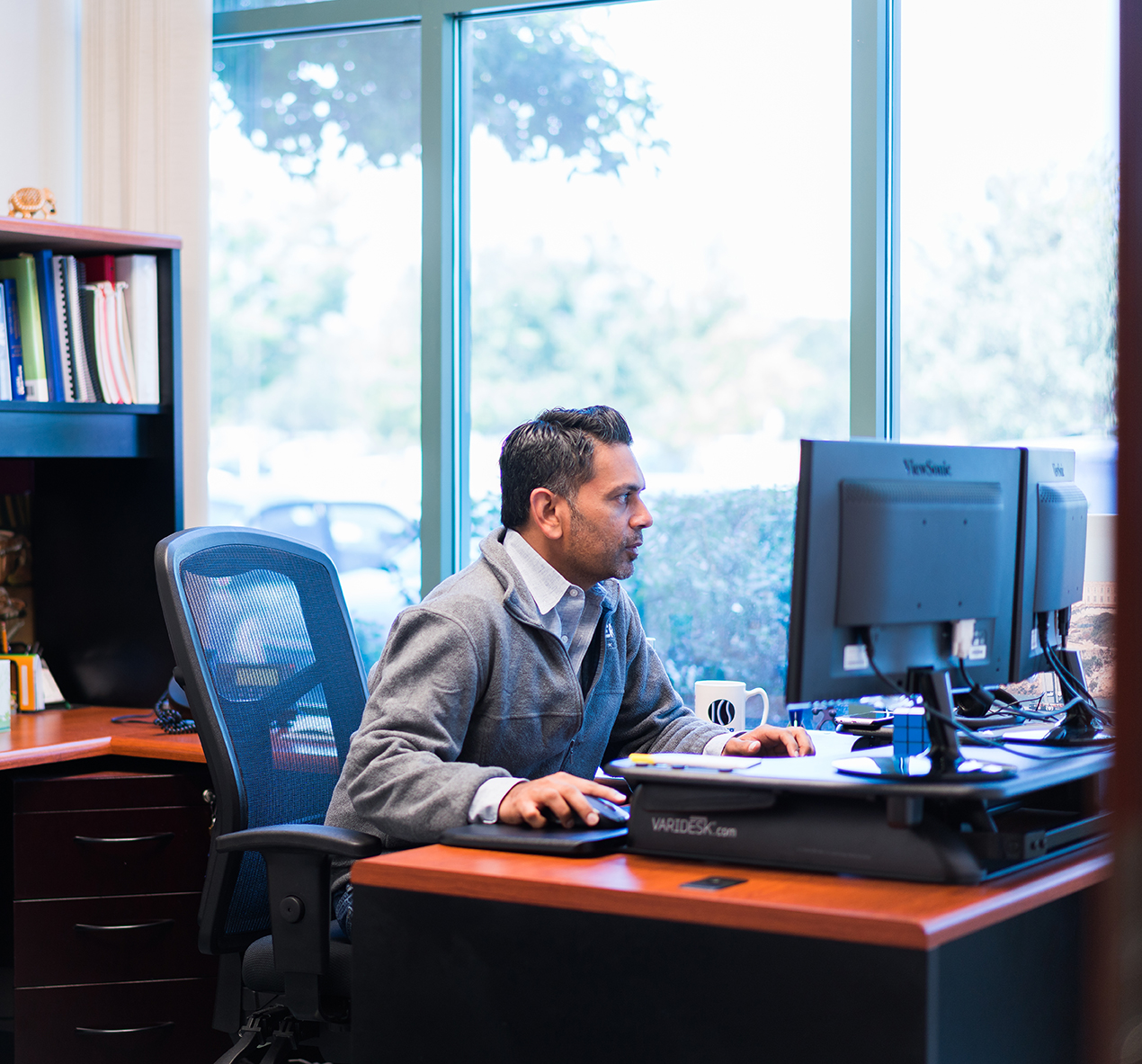 meyer employee at his desk reading his computer